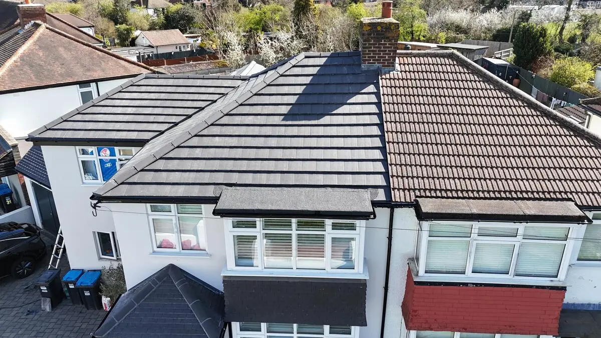 Semi-detached re-roof showing new tiles against old
