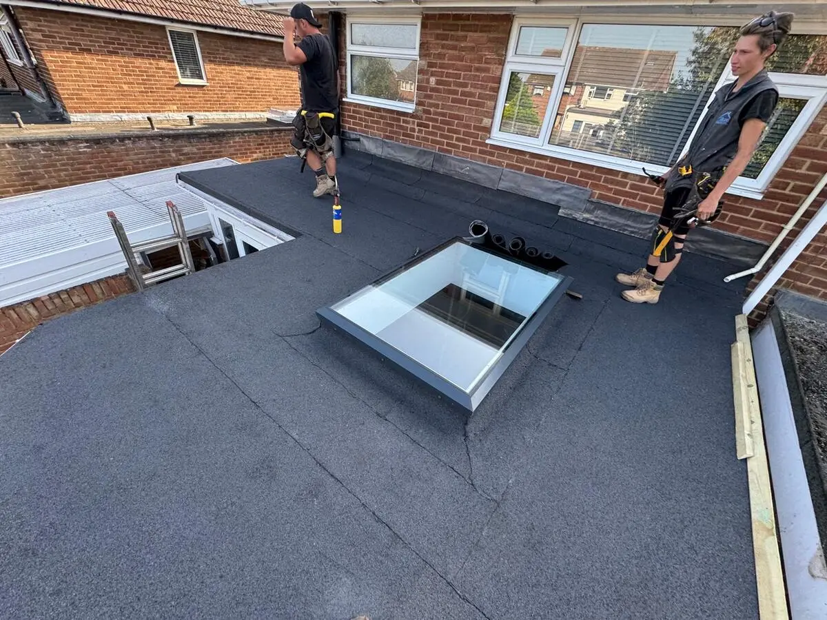 Completed flat roof with skylight installed by Ikon Roofing