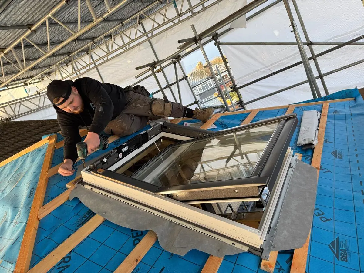Velux roof window being installed with drill on battens
